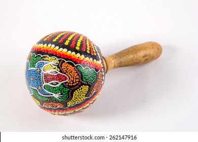 African Ethnic Wooden Shaker Music Instrument Isolated Close-up On White Background With Dot Paint Colorful Motive
