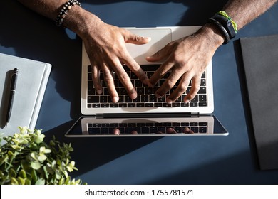 African Ethnicity Businessman Hands Typing Using Laptop Close Up View From Above. Websurfing, Writing Business Letter, Texting E-mail To Clients Or Mailing, E-learning Education Via Internet Concept