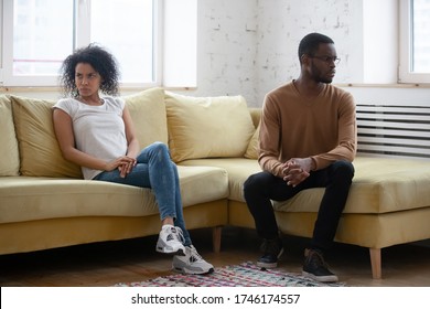 African Ethnicity Family Break Up And Separation Concept. American Wife And Husband Couple After Quarrel Seated On Couch Apart In Silence Thinking Having Relations Problems And Lack Of Understanding