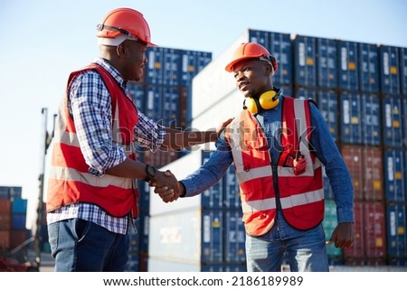 African factory workers or engineer shaking hands together in containers warehouse storage
