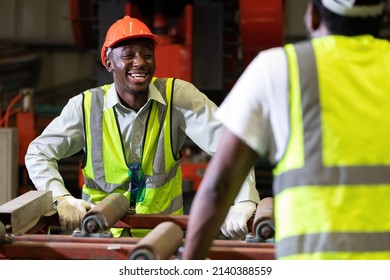 African Factory Workers Or Engineer Talking And Laughing In The Factory