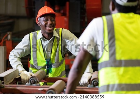 African factory workers or engineer talking and laughing in the factory