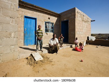 African Family, Grandmother And The Grandchildren, Living  In A Very Poor Village Near Kalahari Desert