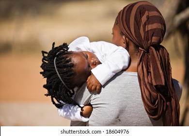 African Family, Mother And Child, Living  In A Very Poor Village Near Kalahari Desert