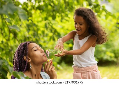 African Family Outside,mother And Daughter In The Park Play With Soap Bubbles, Summer Holidays In Nature, Love And Happiness