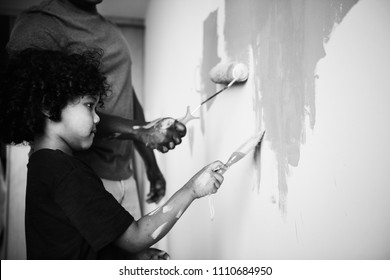 African Family Painting The House Wall