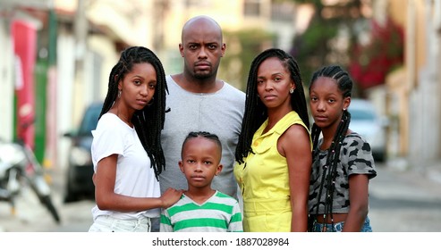 African family photo portrait standing outside. Black parents and children posing to camera