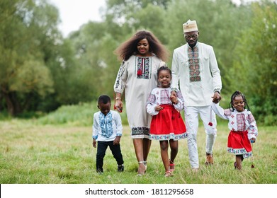 African Family In Traditional Clothes At Park. 