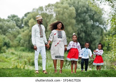 African Family In Traditional Clothes At Park. 