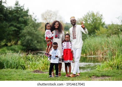 African Family In Traditional Clothes At Park. 