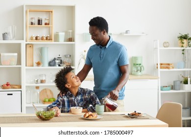 African Family Of Two Father And Son Having Breakfast Together In Domestic Kitchen