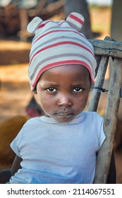 African Farm Child In Rural Africa, And Chicken Running, Village In Botswana