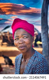 African Farm Woman In Rural Africa, And Chicken Running, Village In Botswana