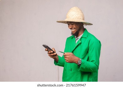 African Farmer Using His Phone And Bank Card