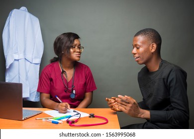 African Female Doctor Having Heart To Heart Discussion With Her Male Patient 