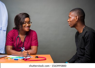 African Female Doctor Having Heart To Heart Discussion With Her Male Patient 