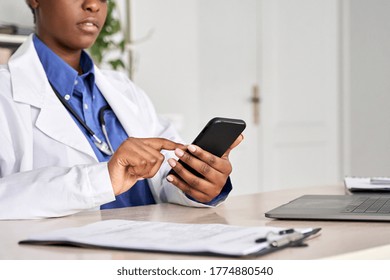 African Female Doctor Holding In Hands Using Cell Phone E Health App Chatting With Patient, Close Up View. Healthcare Telemedicine Online Remote Consultation Mobile Medical Tech Application Concept.