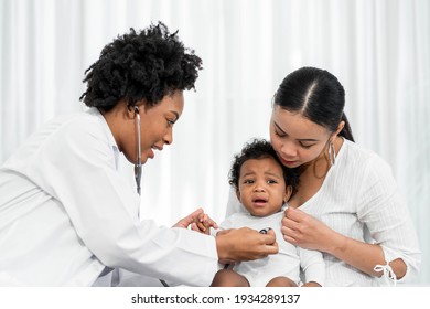 African Female Pediatrician Hold Stethoscope Exam Child Boy Patient Visit Doctor With Mother