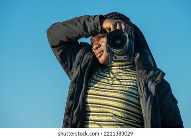 African Female Photographer Looking Towards The Sunset Waiting To Take A Picture Out In Nature