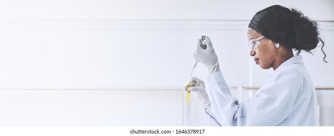 African Female Scientist In Protective Glasses Looking And Testing Tube Chemical In Laboratory, Development For The Future, Medical Sciene Health Care Concept, Banner