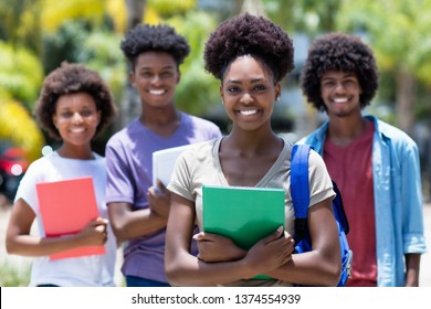 African Female Student With Group Of African American Students Outdoor In The Summer