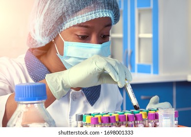 African Female Tech, Technical Assistant, Working With Mouth Swabs, Patient Samples For Detection Of Covid-19, SARS-CoV-2 Novel Coronavirus. Medical Test Lab, Laboratory, Testing Facility Interior.