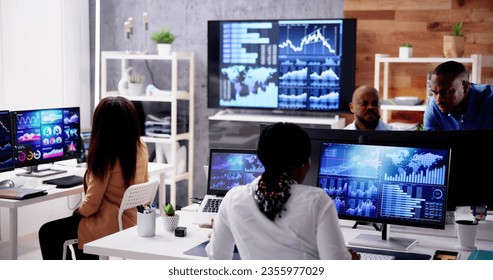 African Financial Data Analysts Using Performance Dashboard On Screens In Office