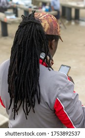 African Fisherman With Dreadlocks Using A Cell Phone