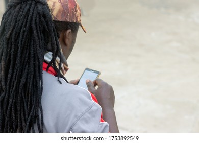 African Fisherman Using A Cell Phone