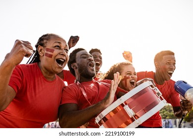 African football fans having fun cheering their favorite team - Soccer sport entertainment concept - Shutterstock ID 2219100199