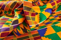 African Ghanaian Colourful Fabrics In A Pile Spread Out On A Table