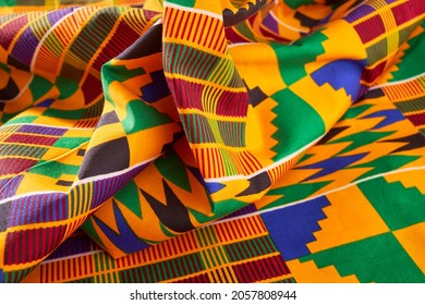 African Ghanaian colourful fabrics in a pile spread out on a table
