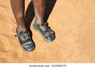 African Girl Broken School Shoes In The Hot Sand Walking In The Desert