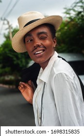 african girl with drawn mustache disguised as a man, cuba style