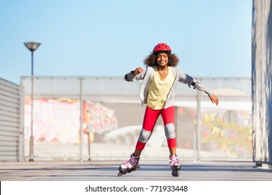 African girl exercising at outdoor rollerdrom