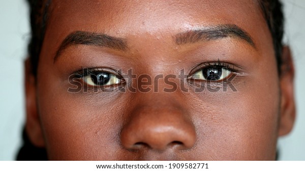 African girl eyes staring camera.
Macro close-up Mixed race young woman eye, casual real
person