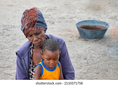 African Granny  With Child In Her Yard In A Village In Botswana