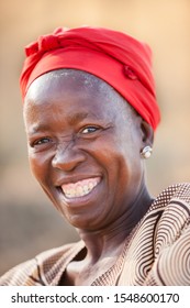 African Granny With Red Scarf Portrait With In A Village In Botswana