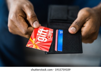 African Hand Holding Gift Card Shopping Voucher