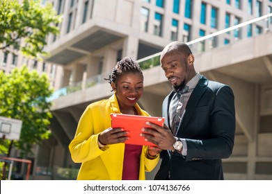 African happy people hold gadget at street urban background