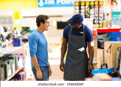 African Hardware Store Salesman Assisting Customer Shopping