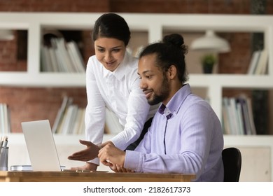 African Intern Sit At Desk Listens To Female Indian Mentor Tells About Task, Explain Company App, New Corporate Software Pointing On Laptop, Mates Prepare Online Presentation. Internship, Help Concept