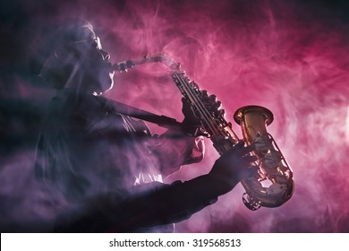 African jazz musician playing the saxophone. Red Color - Powered by Shutterstock