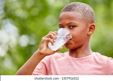 African Kid Drkining Water From Plastic Cup