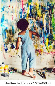 African Kid Painting On Wall