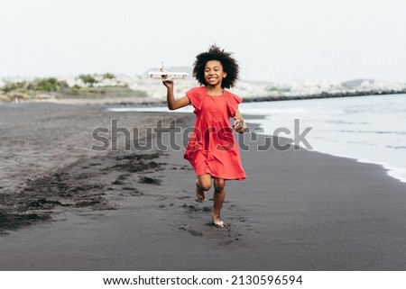 Similar – Image, Stock Photo A baby girl is spoon fed with yogurt by her mother