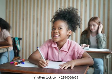 African Kids Drawing And Do Homework In Classroom, Young Girl Happy Funny Study And Play Painting On Paper At Elementary School. Kid Drawing And Painting At School 