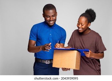 african lady filling a manifest to receive a package from a delivery worker