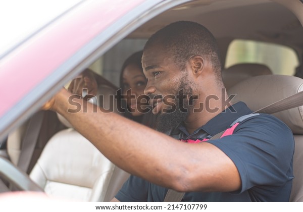 african lady giving a\
driver directions