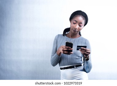 An African lady making a mobile payment on a mobile device
